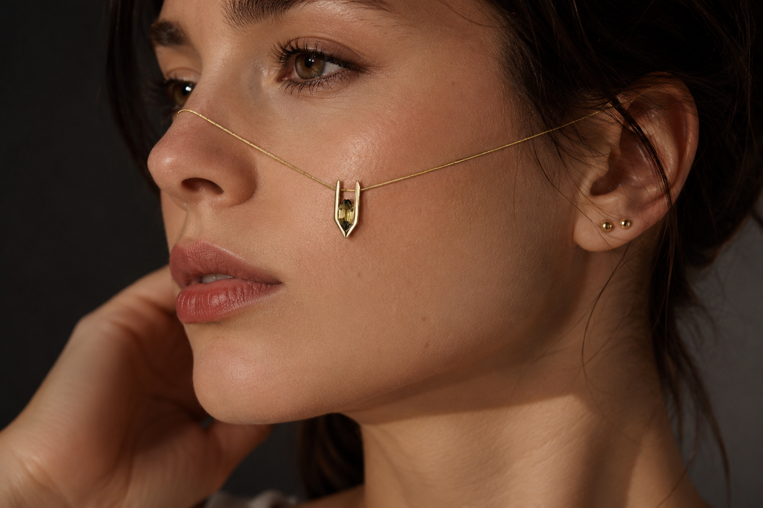 Artisan gold sapphire pendant necklace worn by a woman, handcrafted designer jewellery created in the JYOCO Jewellery studio