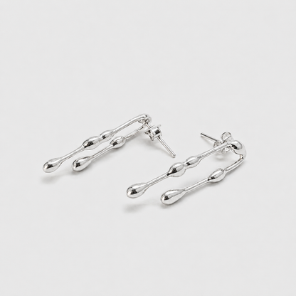 Pair of silver earrings on a light gray background
