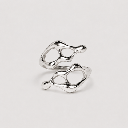 Silver ring with a unique design on a light gray background