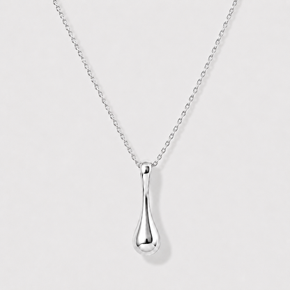 Silver teardrop pendant necklace on a light gray background
