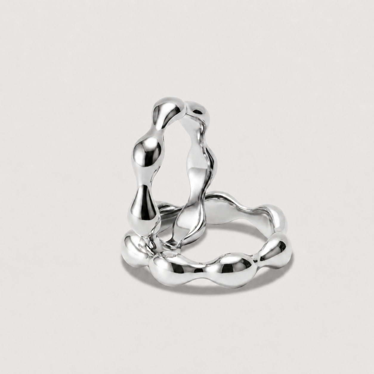 Silver ring with a modern design on a light gray background