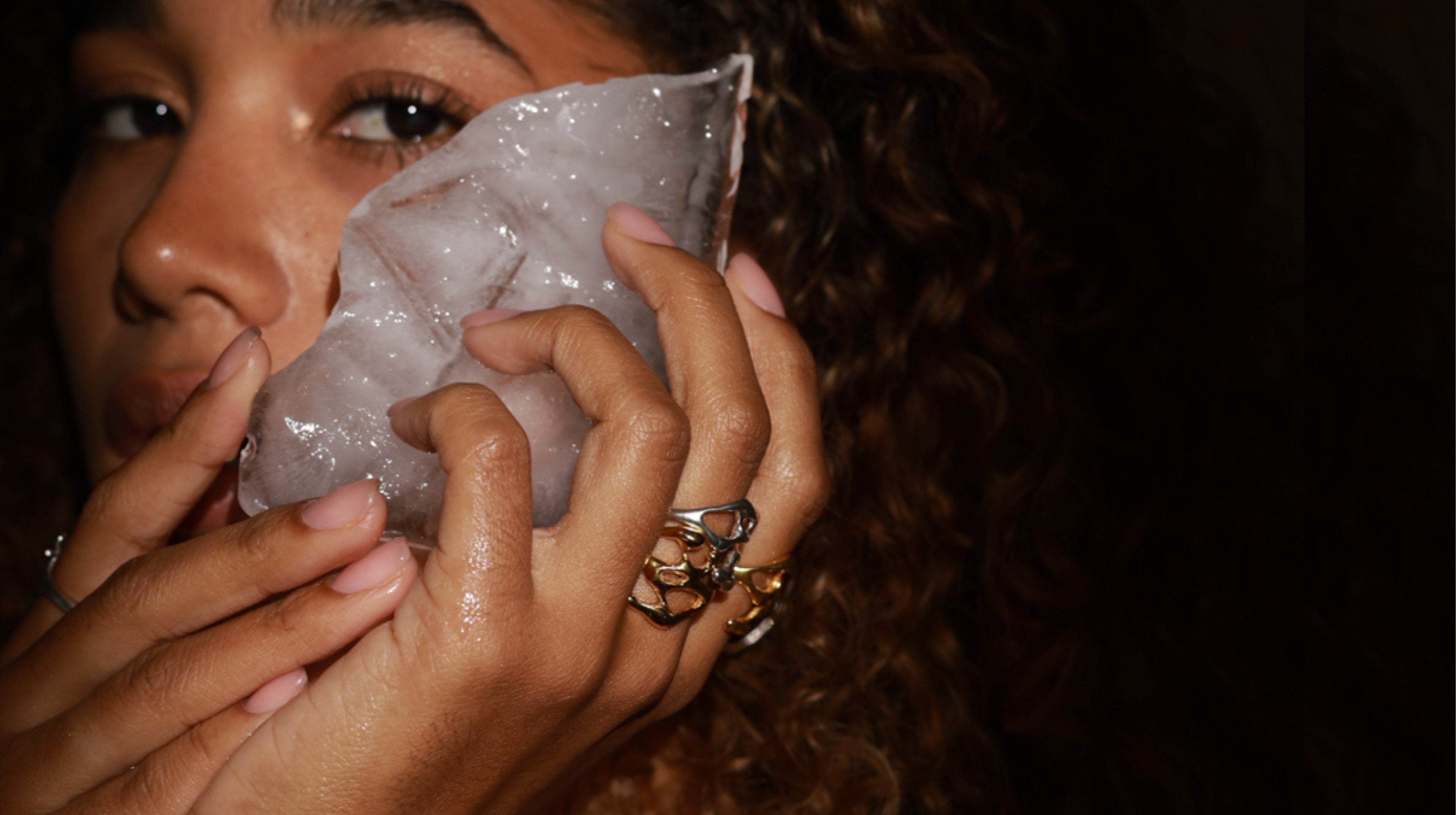 Person holding a clear plastic bag with a dark background