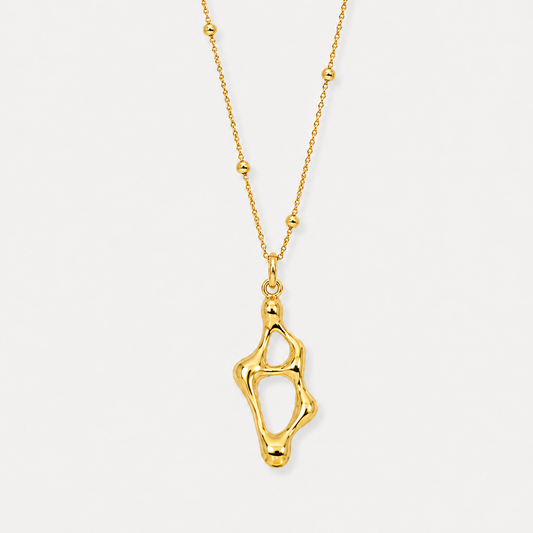 Abstract sculptural gold pendant necklace with organic open form on delicate beaded chain