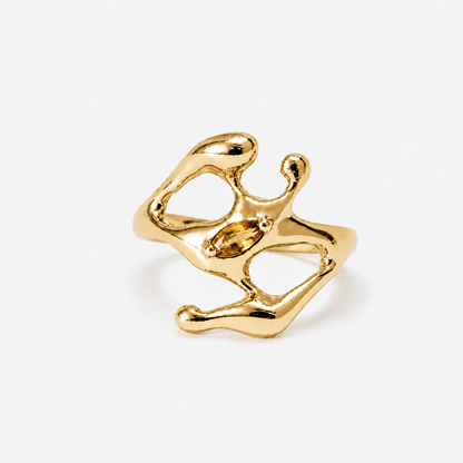Gold ring with a yellow gemstone on a white background