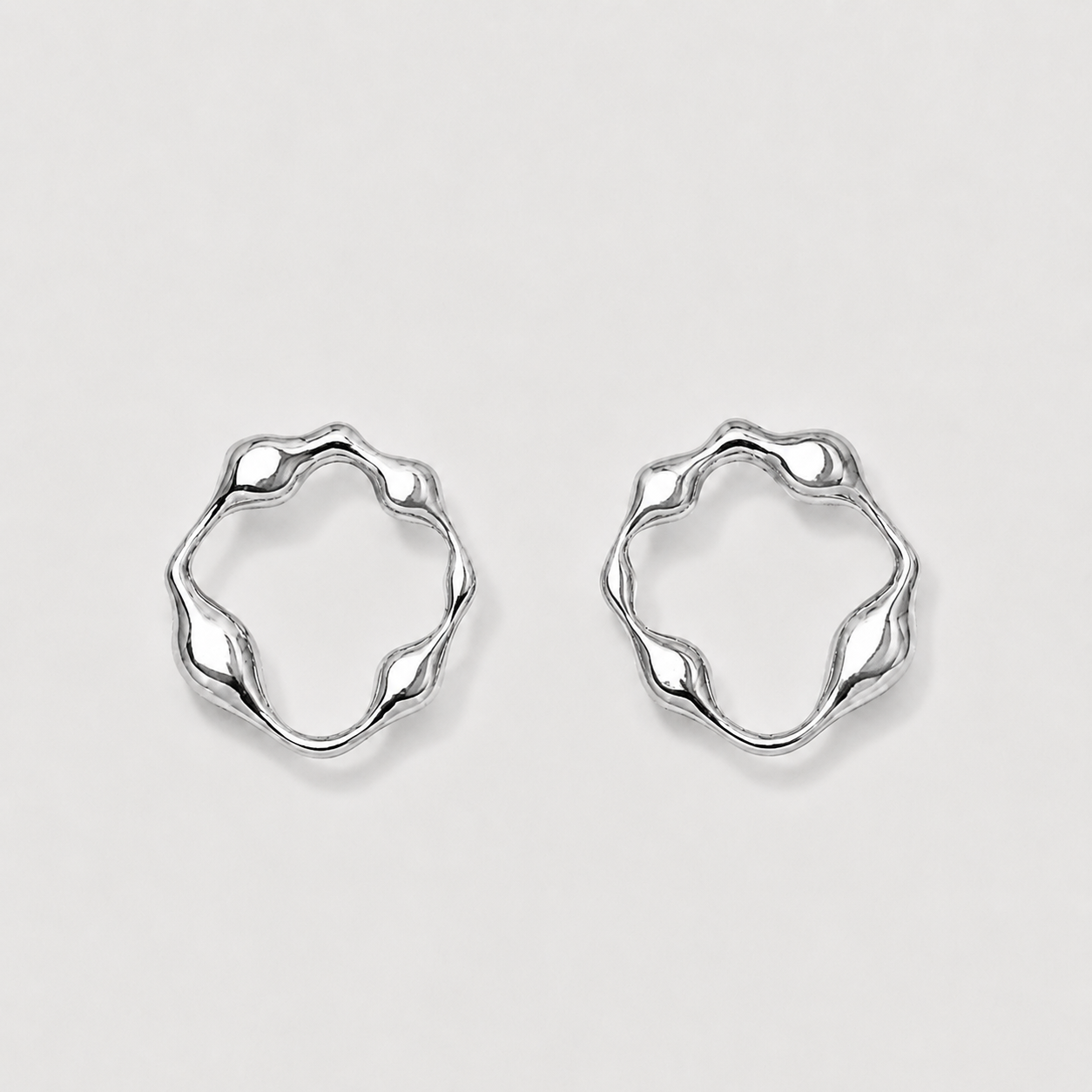 Pair of silver hoop earrings on a light gray background