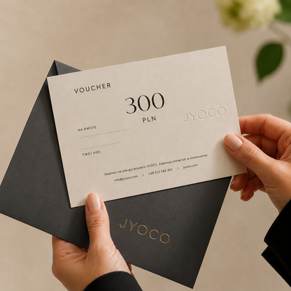 JYOCO voucher held by a person with a black envelope on a neutral background